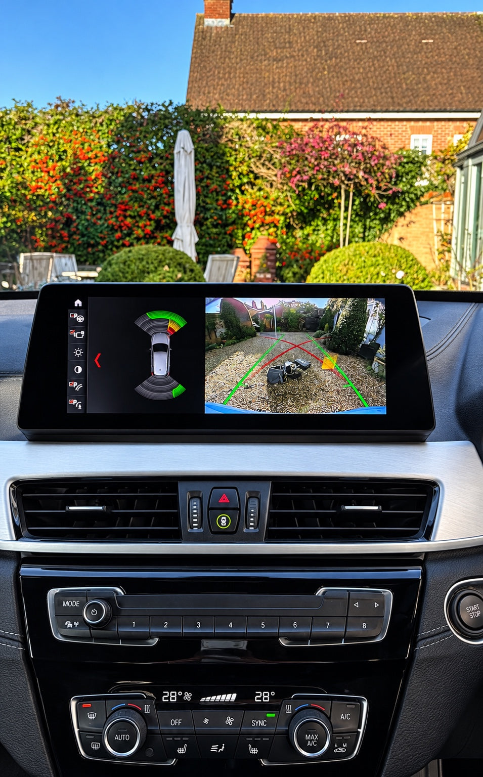 BMW OEM reverse camera with parking sensors on iDrive screen