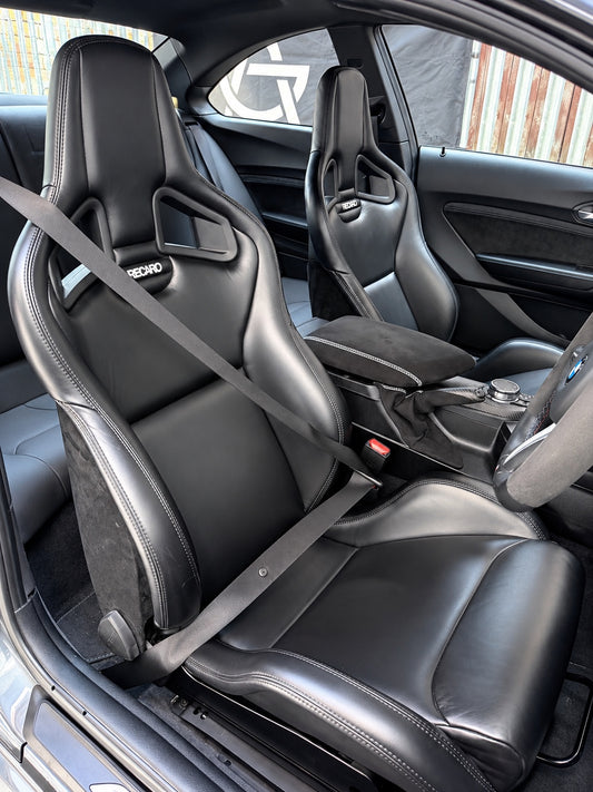 BMW Recaro race seats installed with seat belt in vehicle interior